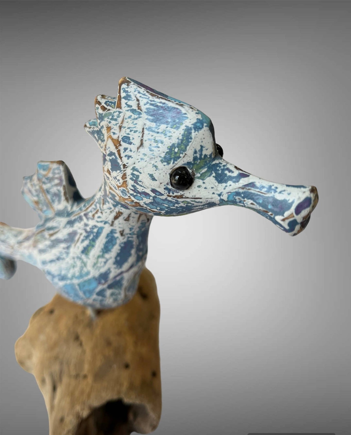Wooden carved painted seahorse on driftwood wood base
