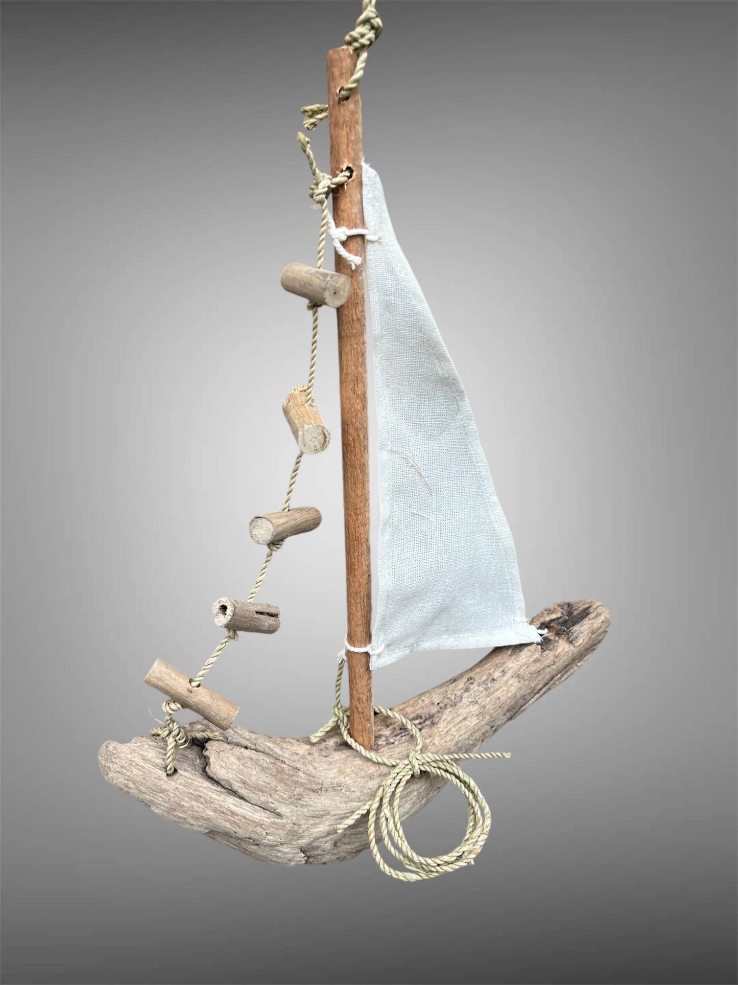 Hanging driftwood boat mobile.